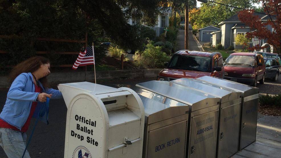 Kim Keller of Ashland drops off a ballot for a friend in the voting drop behind the Ashland Public Library. (Daily Tidings file photo)